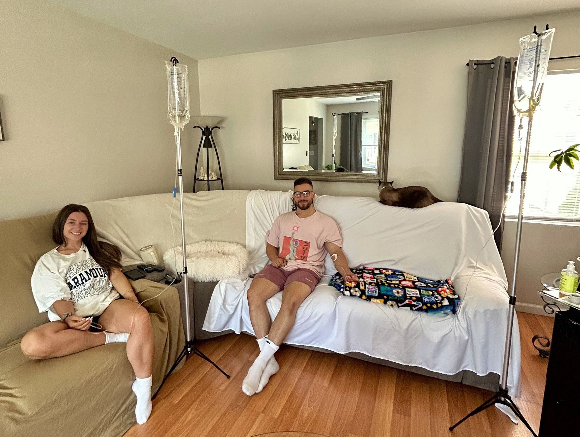 A man and a woman are sitting on a couch in a living room.