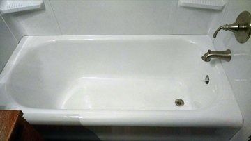 A white bathtub with a faucet in a bathroom.