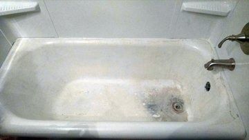 A white bathtub with a faucet in a bathroom.