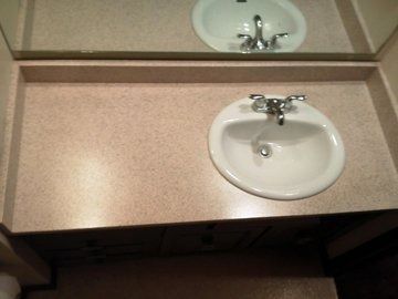 A bathroom sink with a mirror on top of it.