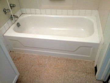 A white sink with three faucets is sitting on a counter in a bathroom.