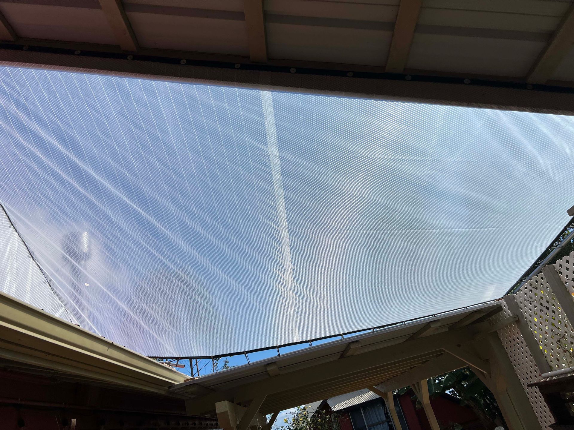 A clear roof with a blue sky in the background.