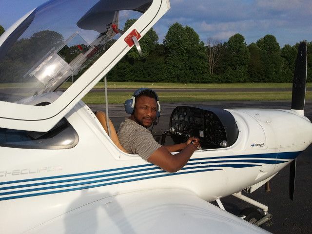 a man is sitting in the cockpit of a small plane
