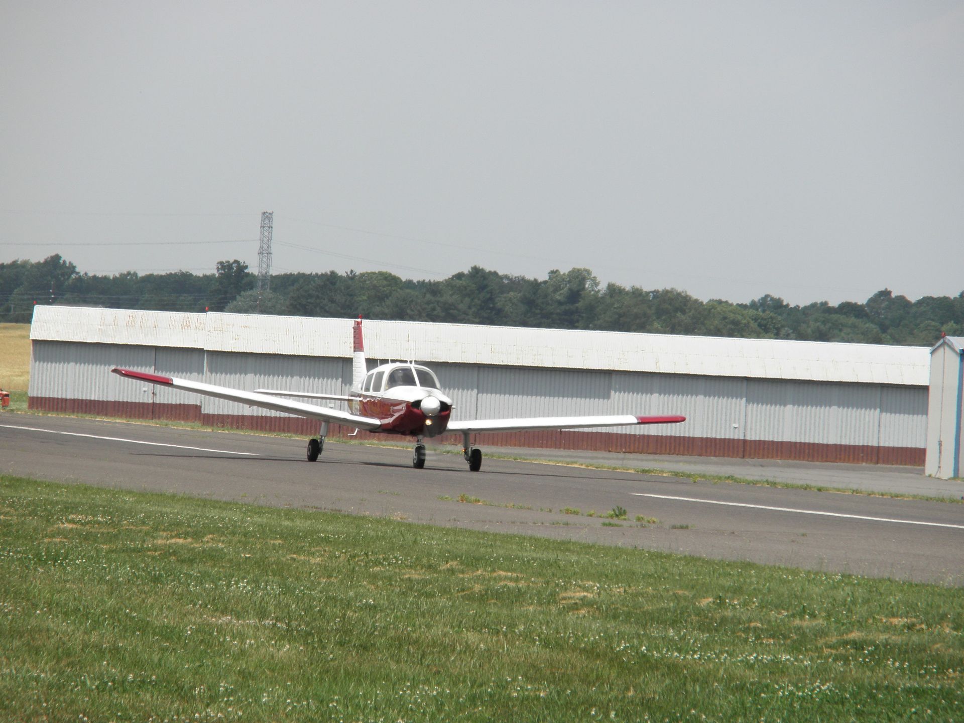 a small red and white plane is sitting on a runway