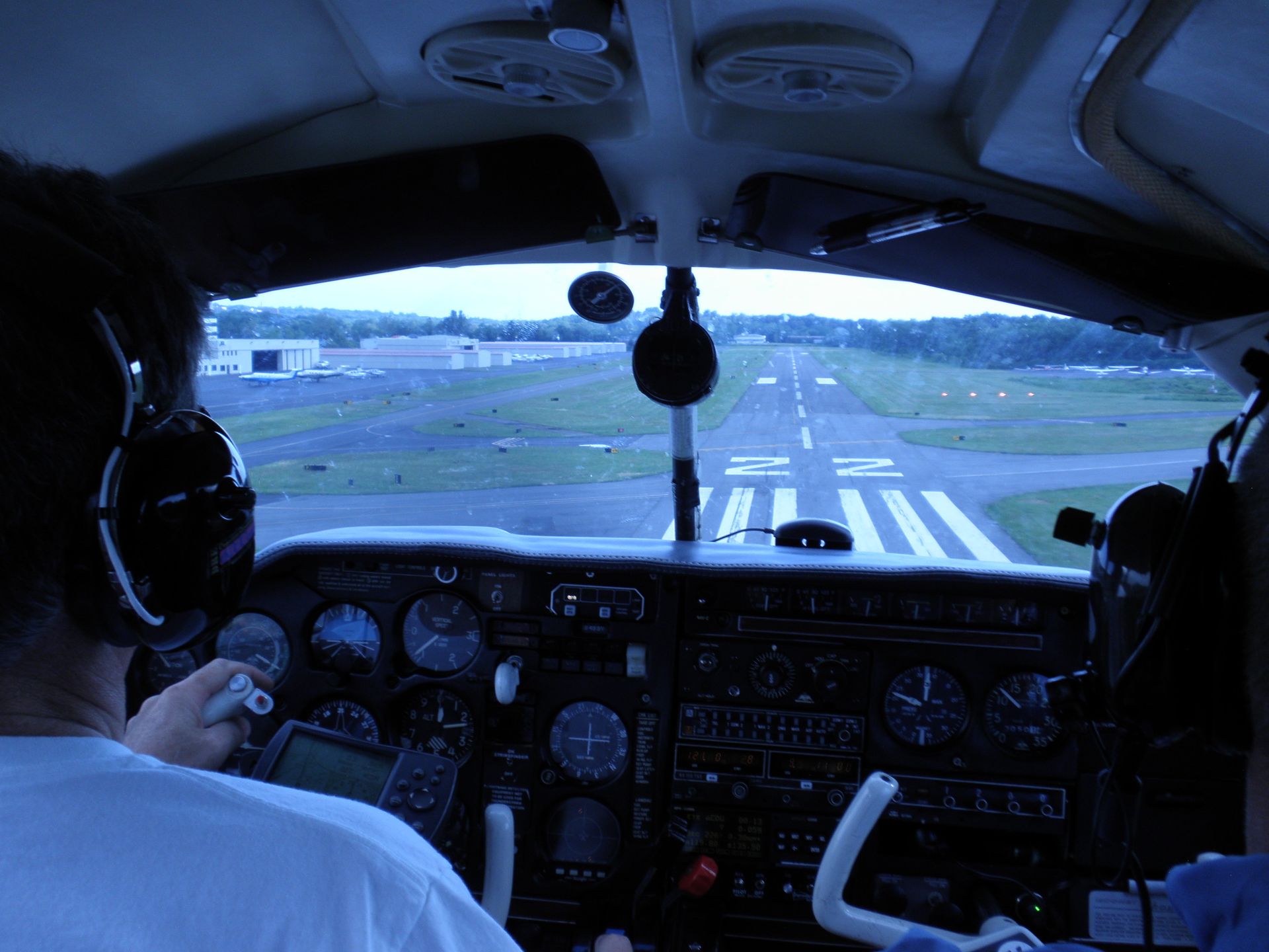 a cockpit of an airplane with a runway in the background