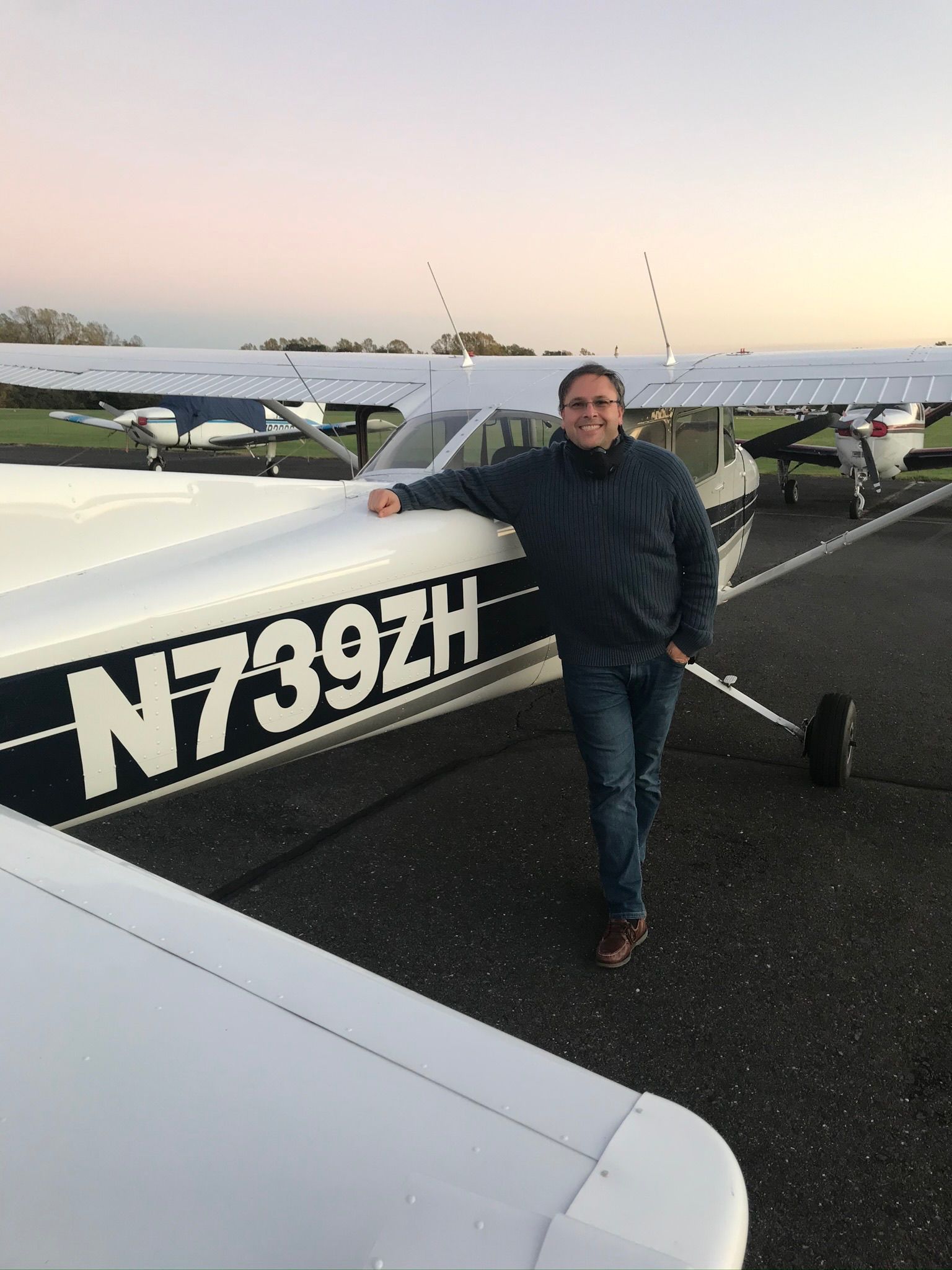 a man is standing in front of a plane with the numbers n739zh on it