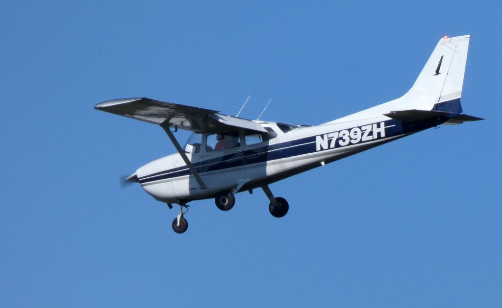 a small plane with n7392h on the side is flying in the sky