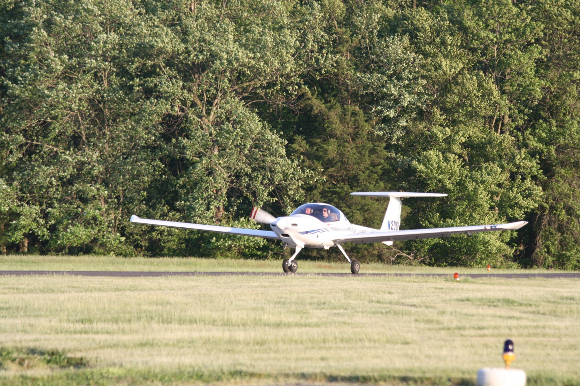 a small plane is taking off from an airport runway