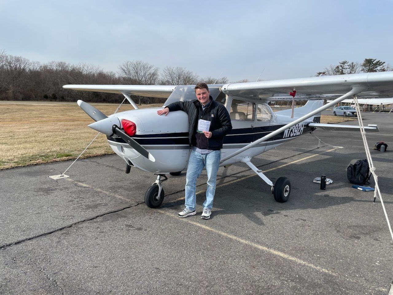 a man is standing in front of a small plane