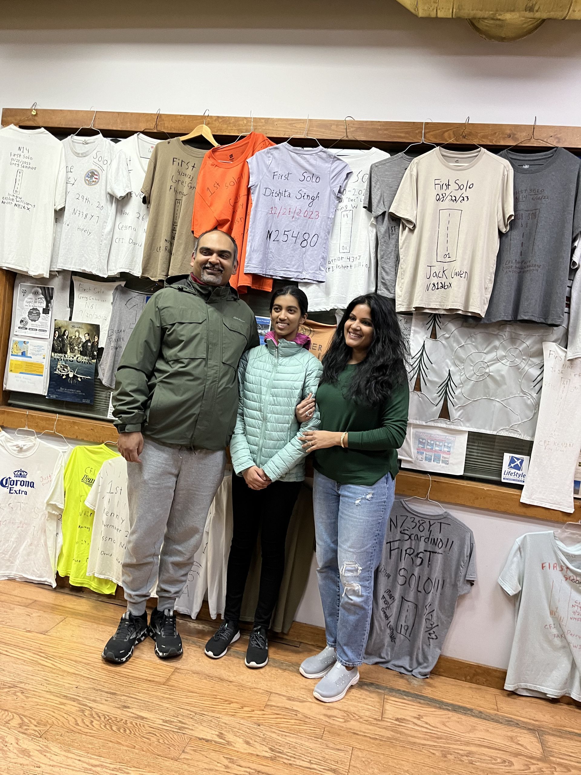 a group of people are posing for a picture in a clothing store