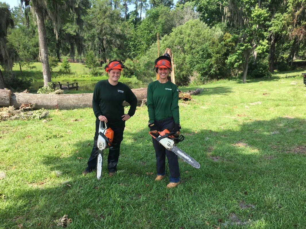 Happy staff holding power saw