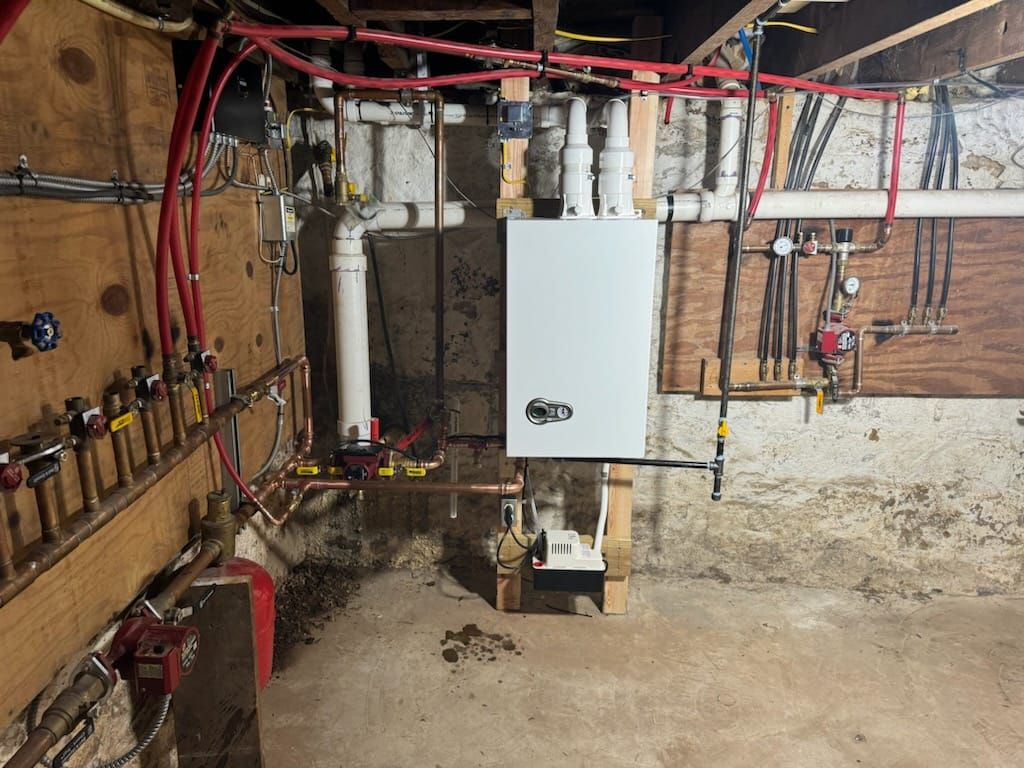 Ocean waves crashing, showing white foam against teal and dark blue water.