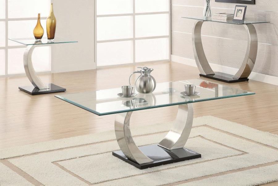 A living room with a glass coffee table and two side tables