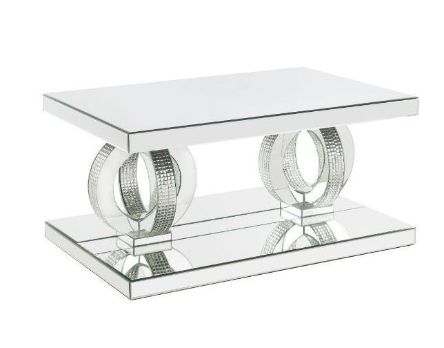 A mirrored coffee table with two circles on the base
