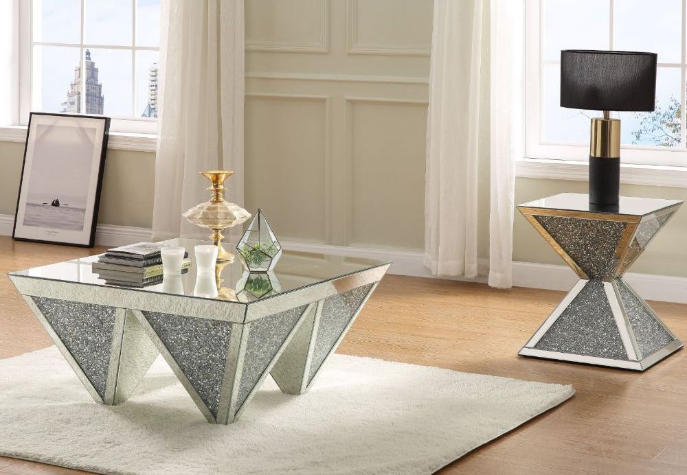 A living room with a coffee table and a lamp.