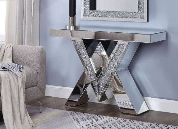 A living room with a couch a lamp and a mirror