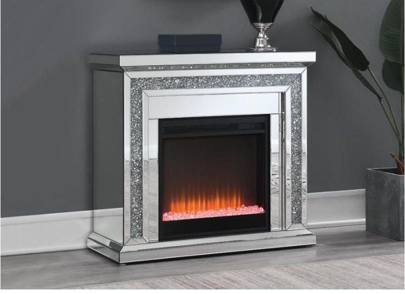 A fireplace in a living room with a picture on the wall above it