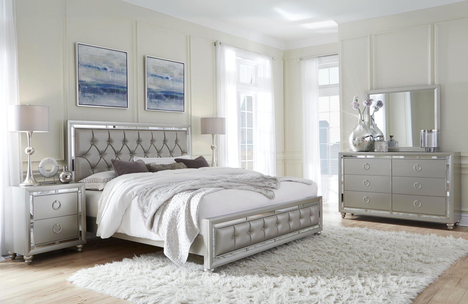 A bedroom with a bed , dresser and mirror