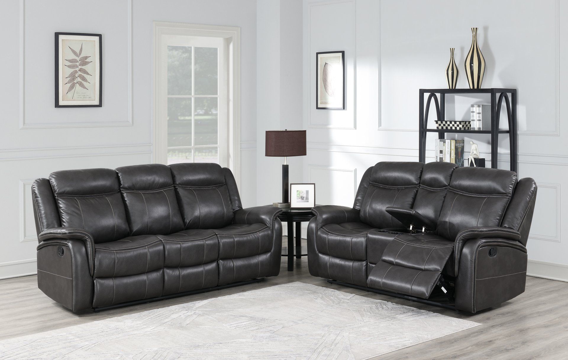 A living room with two black leather reclining couches.