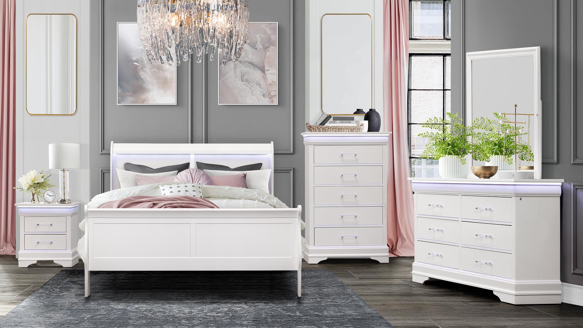 A bedroom with a bed, dresser, nightstand, mirror and chandelier.