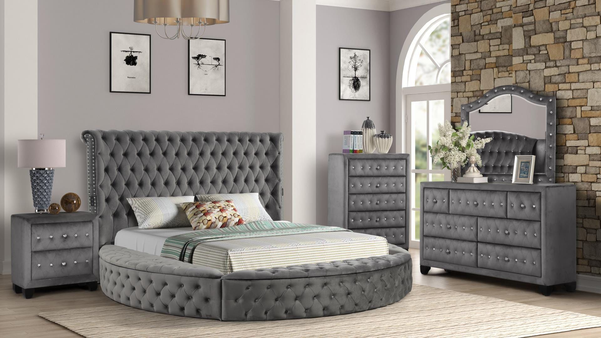 A bedroom with a round bed, dresser, nightstand, and mirror.