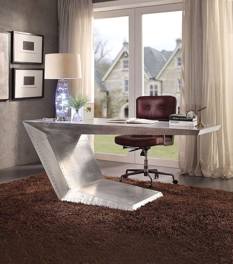 A desk with a chair in front of a window