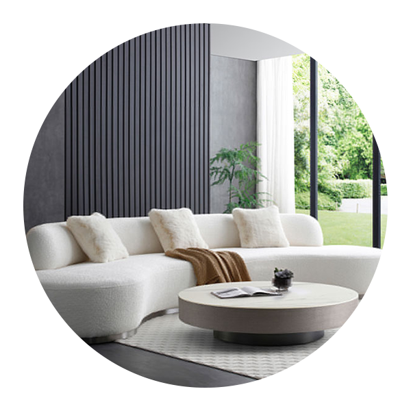 A living room with a white sectional couch and a round coffee table