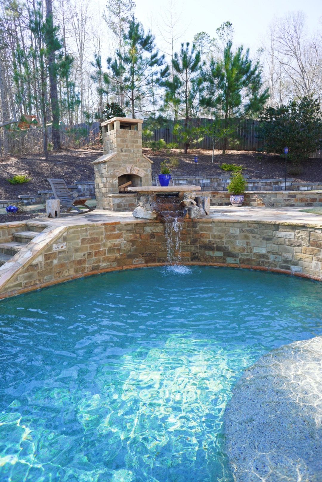 There is a waterfall in the middle of the pool.