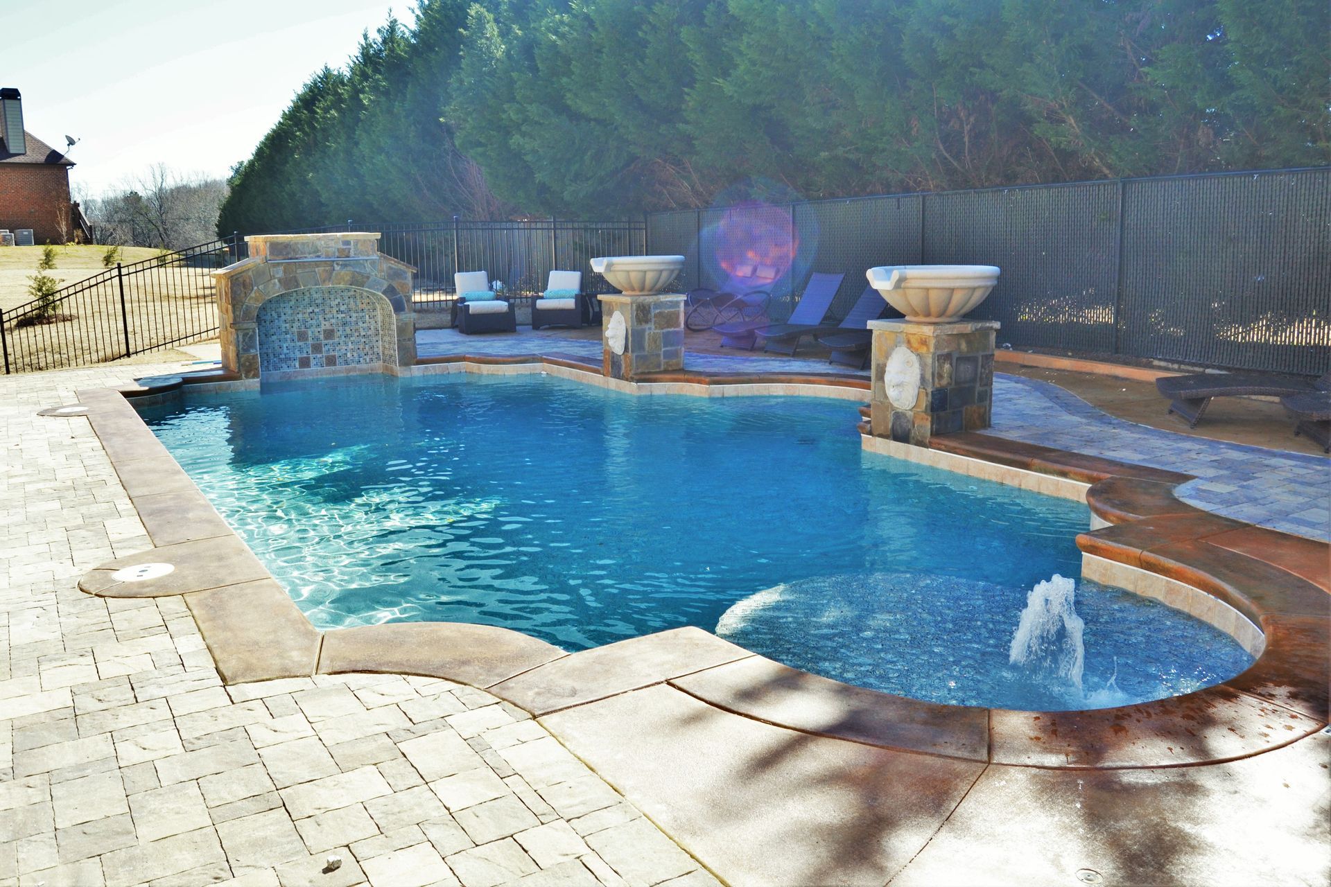 A large swimming pool with a fountain in the middle