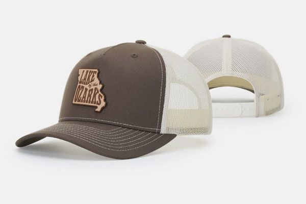 A brown and white hat with the word arkansas on it