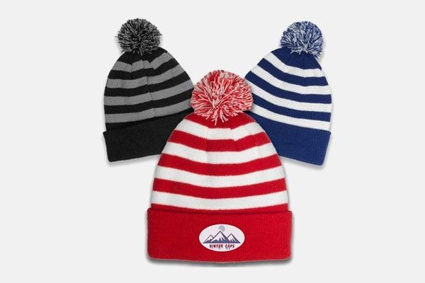 Three striped beanies with pom poms on a white background