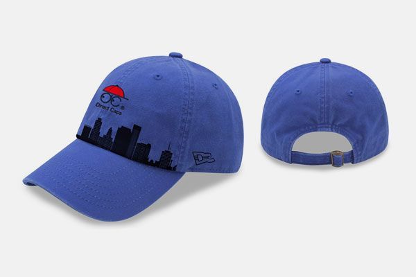 A blue baseball cap with a city skyline on it
