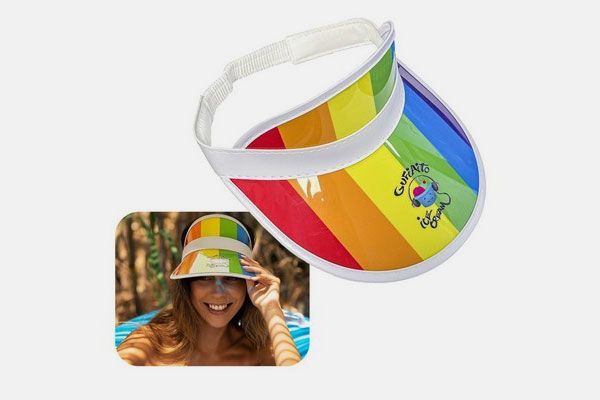 A woman is wearing a rainbow colored visor.