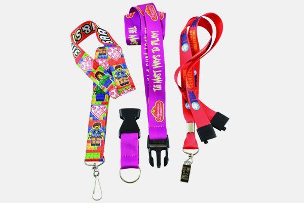 A bunch of lanyards are sitting on top of each other on a white background.