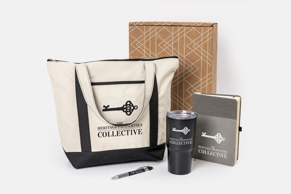 A tote bag with a key on it is surrounded by other items