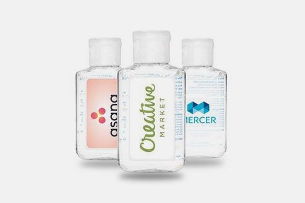 Three bottles of hand sanitizer with different logos on them