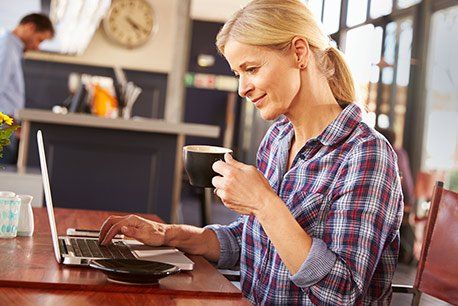 Woman using café guest wi-fi