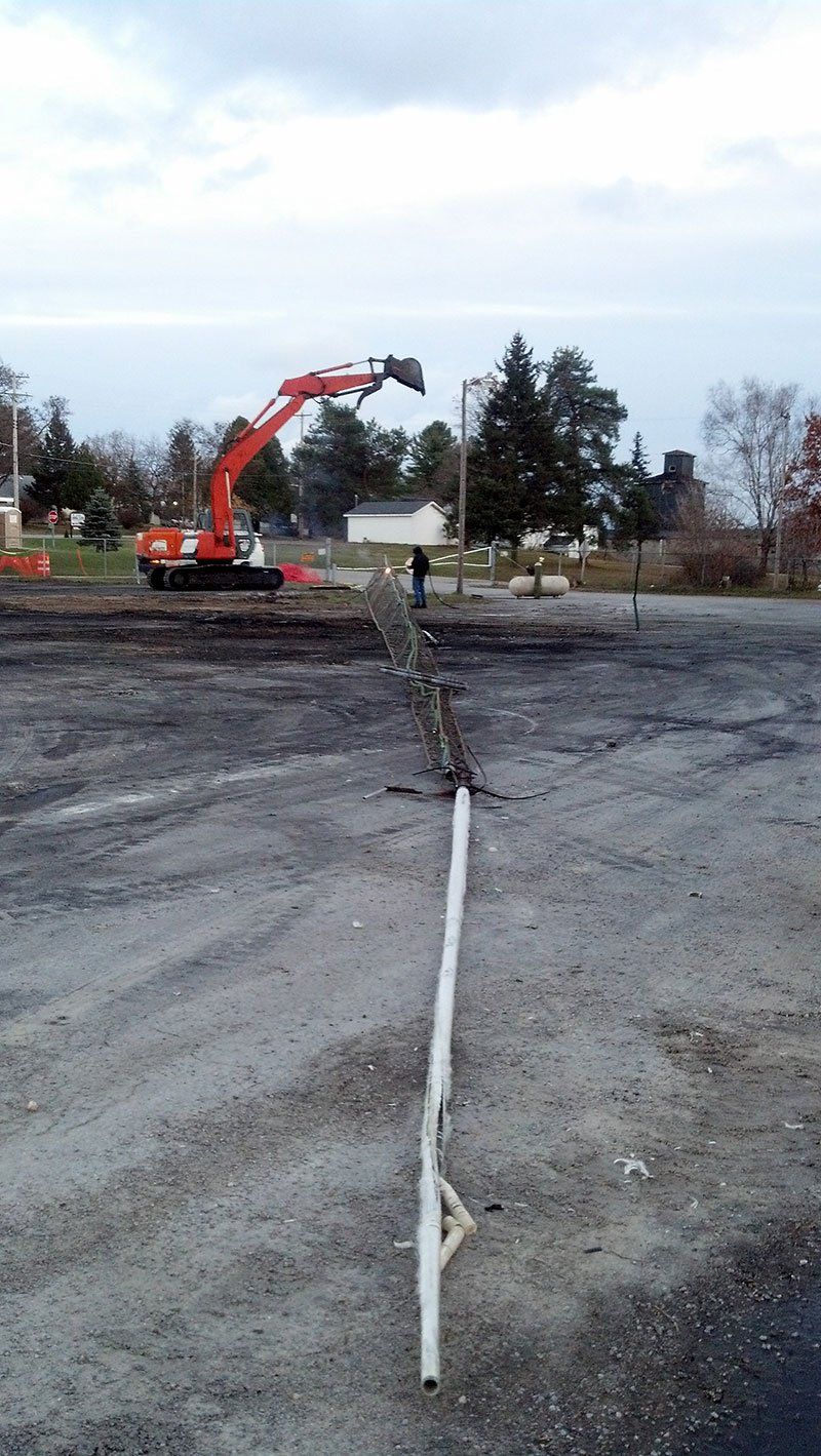 white metal bar lying on the ground
