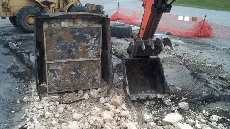 demolition equipment near the debris
