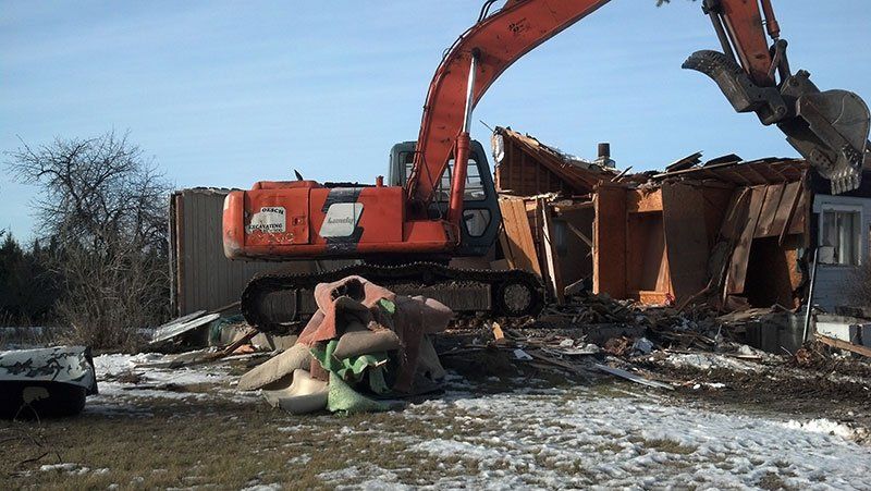 equipment demolishing the farmhouse