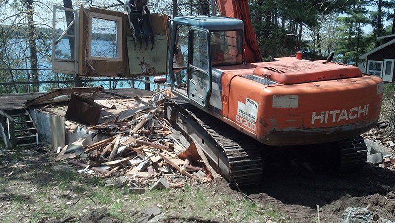 equipment demolishing the lake house