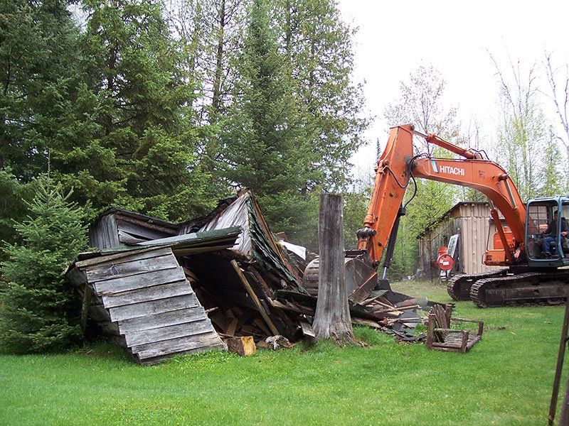 demolition equipment near the small cabin