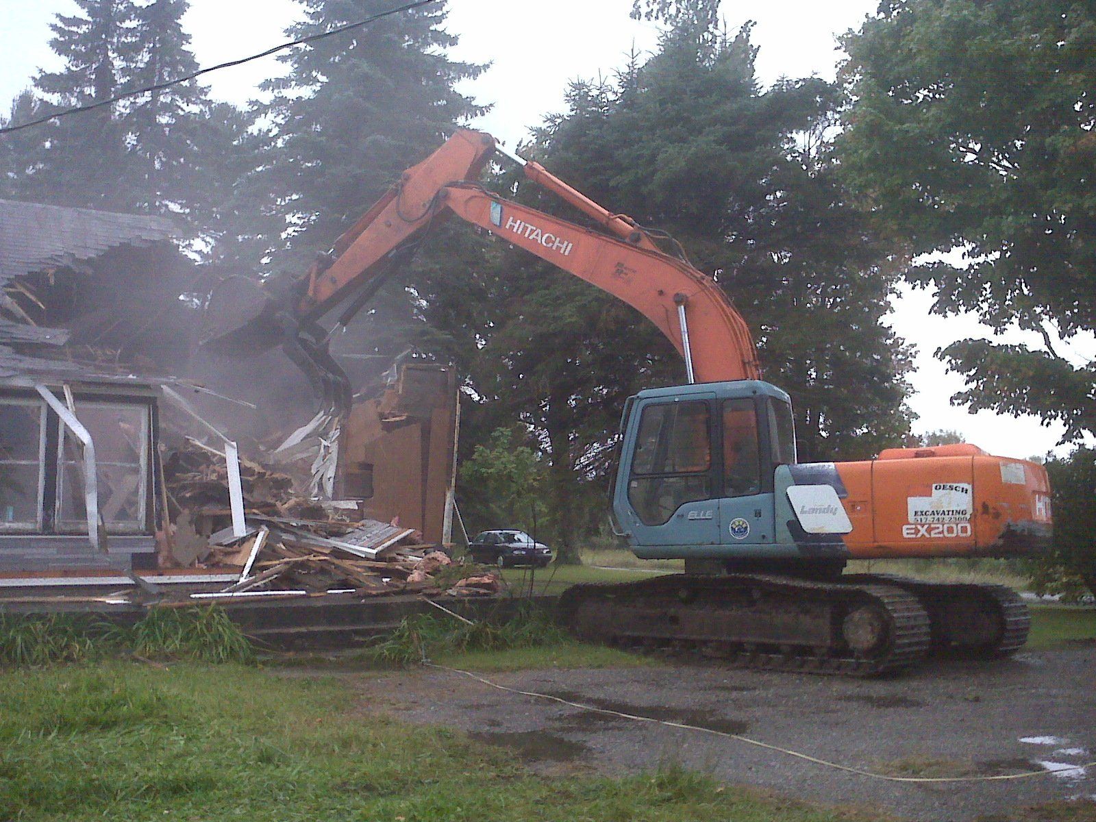 home getting demolished by heavy equipment