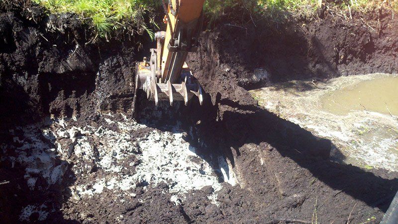heavy equipment trenching wet land