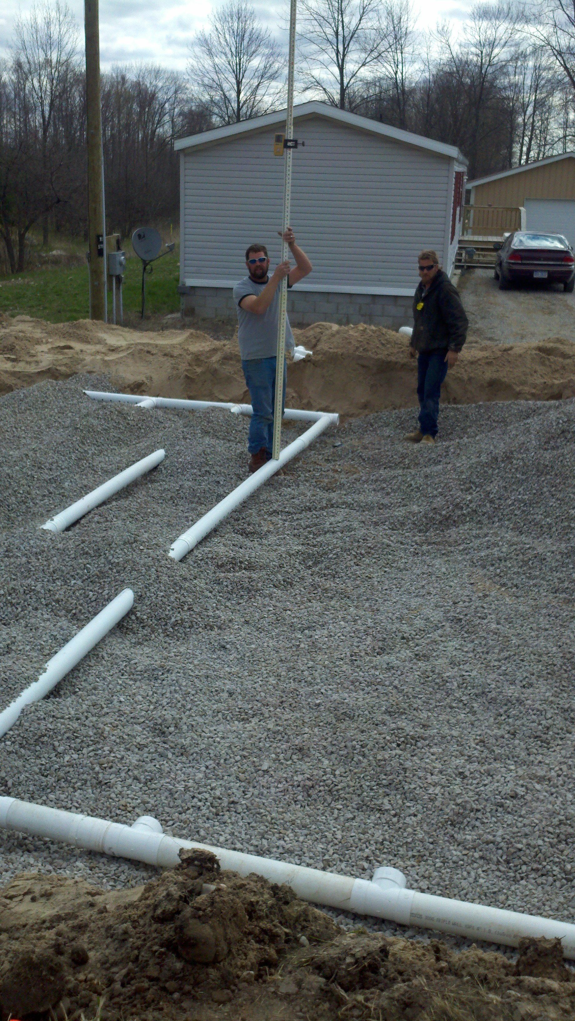 workers installing septic system pipes
