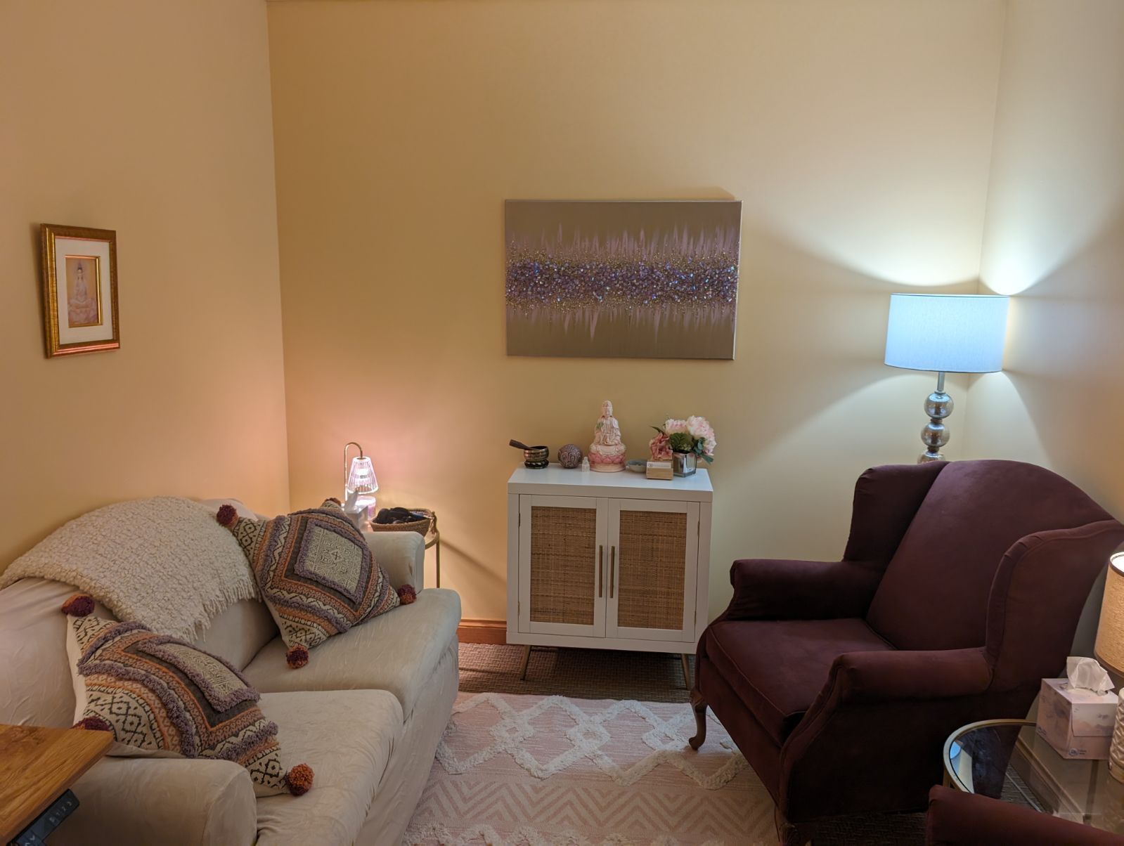 A living room with a couch and two chairs