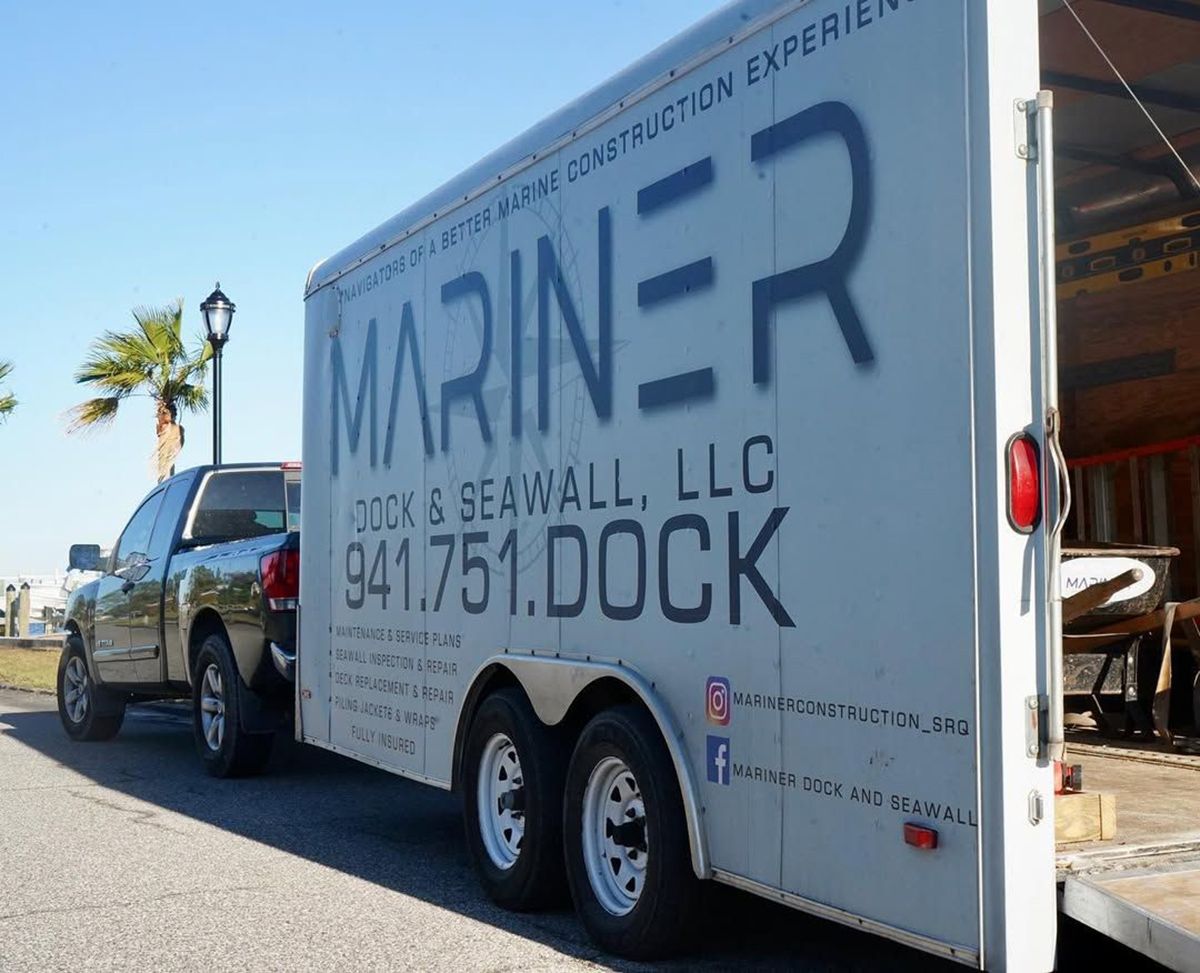 A pickup truck hauls a trailer branded 