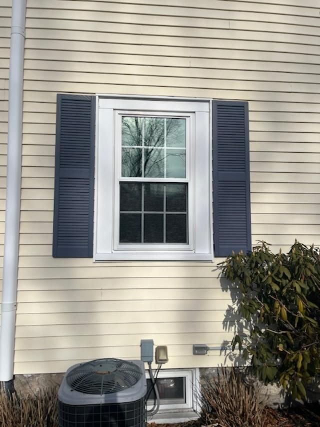 A white house with blue shutters and a window