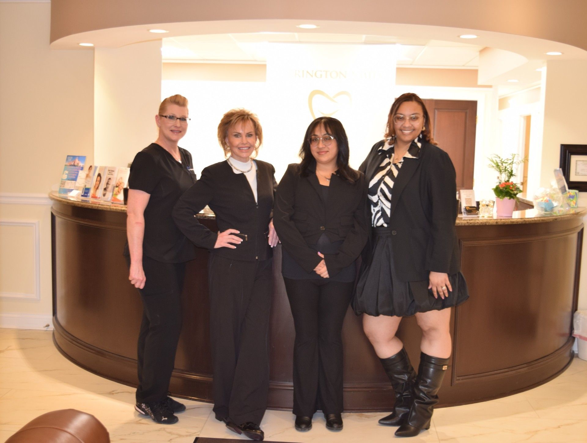 A group of people are posing for a picture and one woman is holding a certificate.