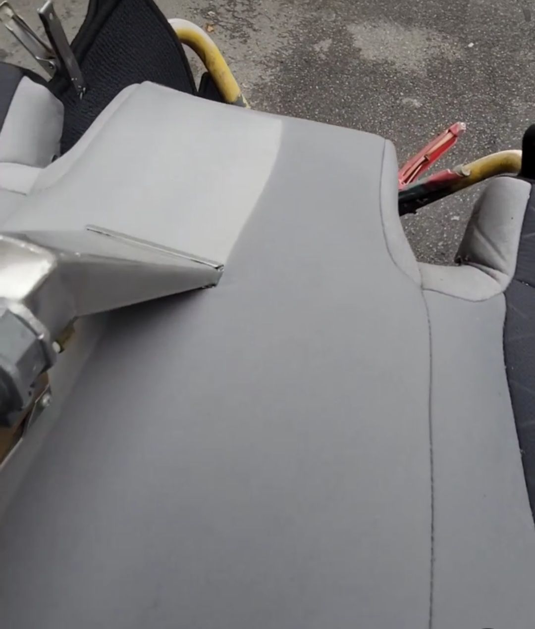 a close up of a gray chair with a pair of pliers on it